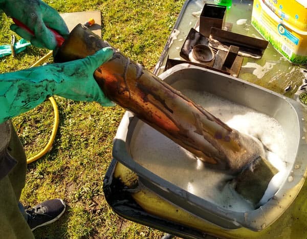 Cleaning the ooni chimney with a brush