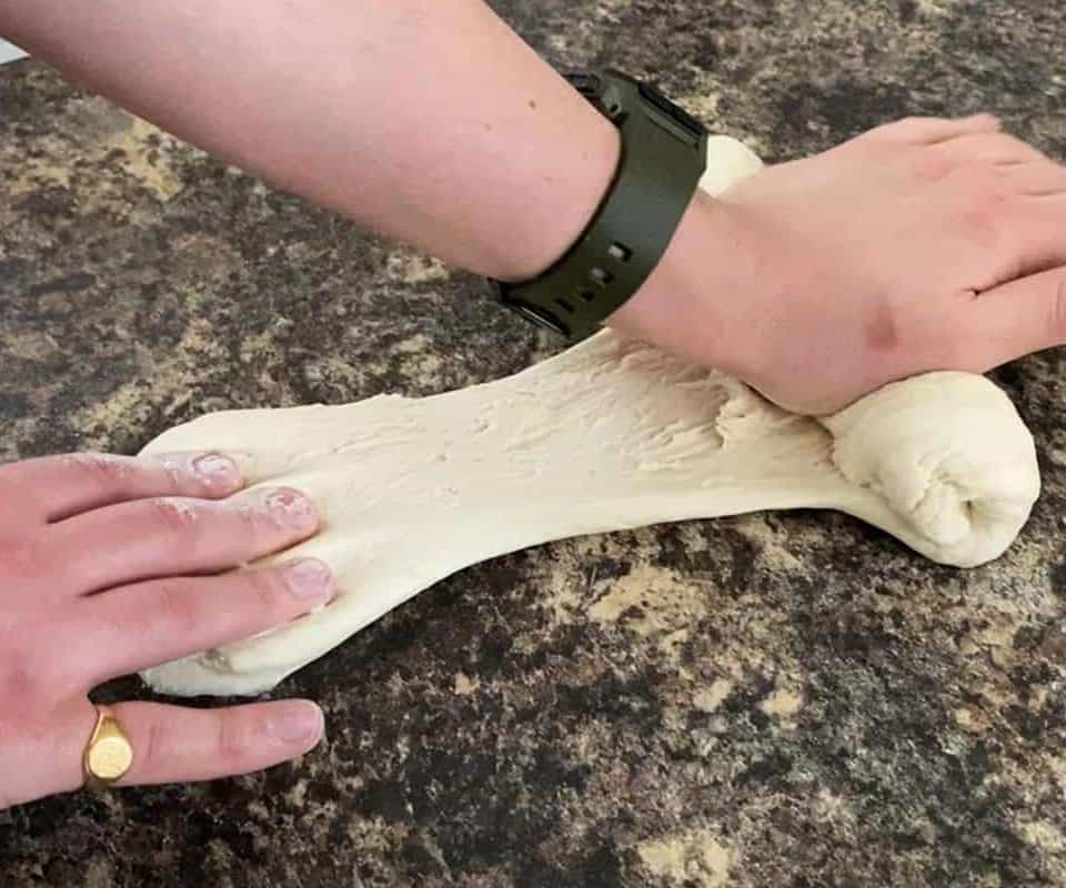 Kneading pizza dough by hand