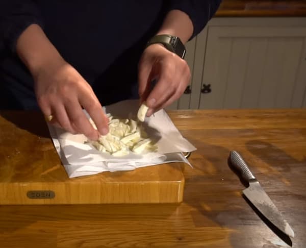 Slicing fresh mozzarella for sourdough pizza