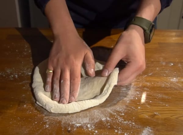 Shaping NYC pizza dough