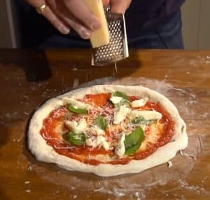 Topping stretched pizza