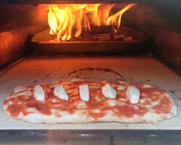 Focaccia pizza cooking in pizza oven